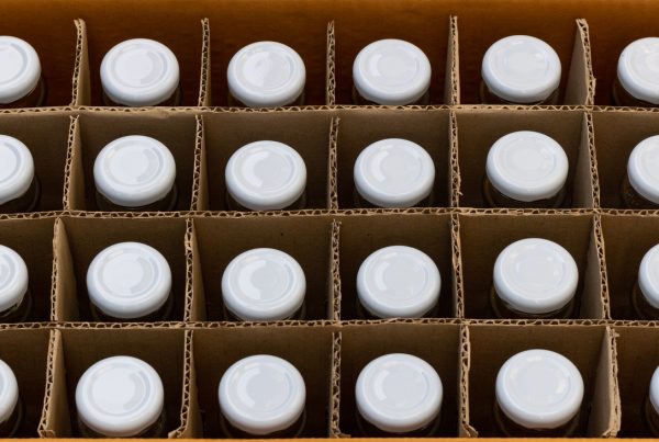A closeup of bottles in corrugated packaging, depicting food and beverage packaging services