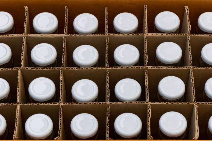 A closeup of bottles in corrugated packaging, depicting food and beverage packaging services